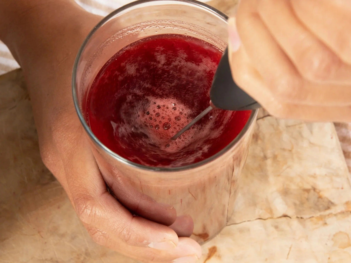 Woman drinking Liv120 Longevity Rx for Cellular Health