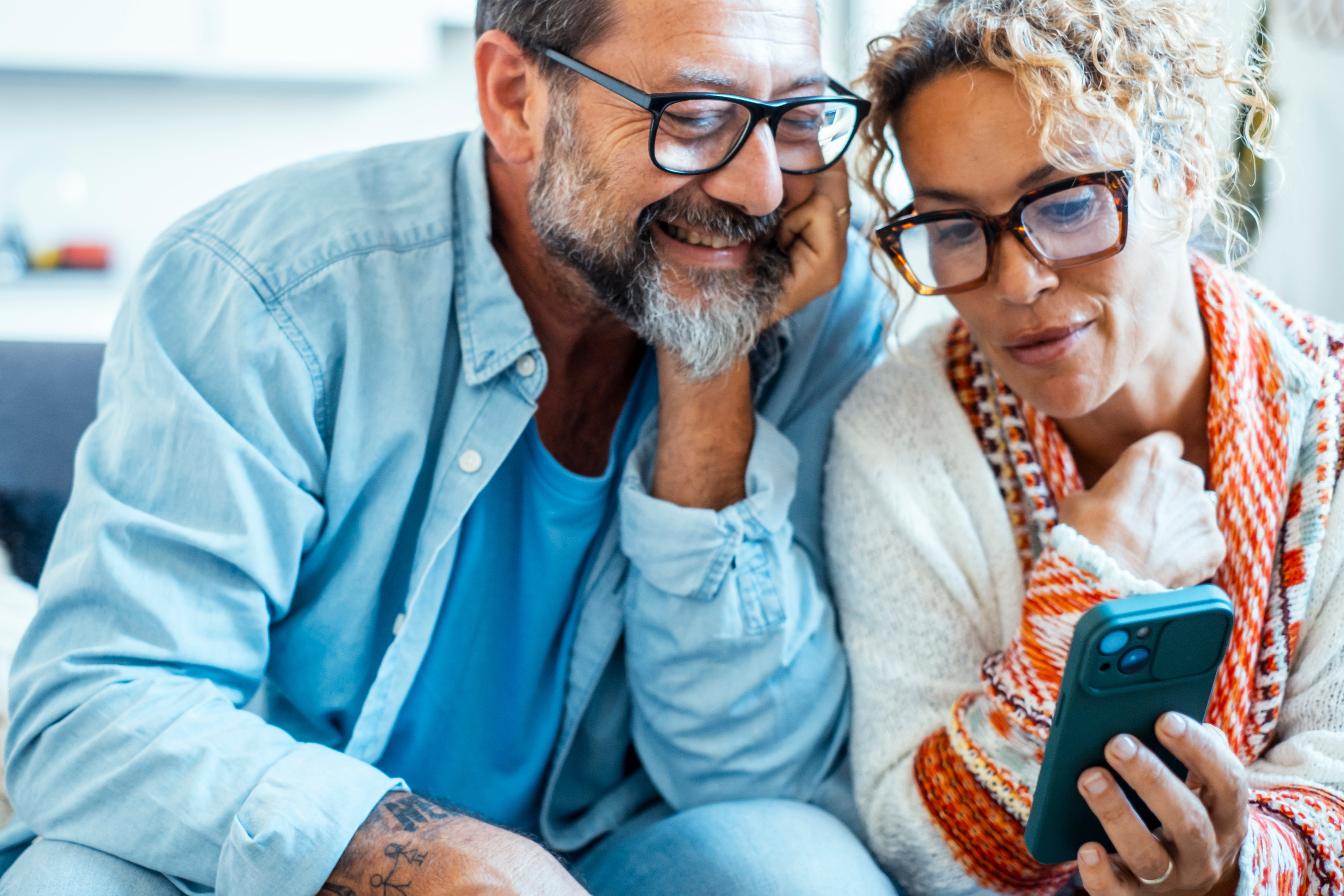Couple sitting together looking at a phone